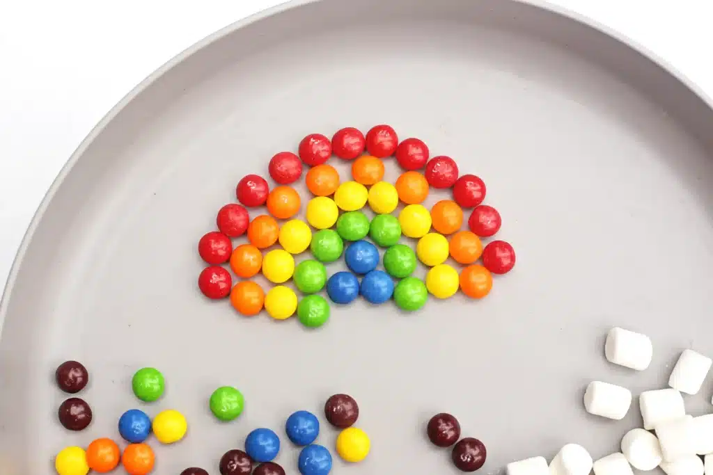 Skittles Rainbow Fine Motor Activity - Cultivating Brilliant Minds skittles arranged into a rainbow