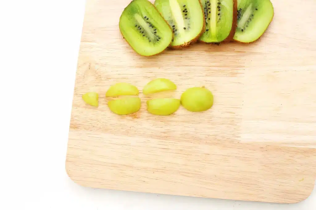 Yertle the Turtle Fruit - Cultivating Brilliant Minds grapes cut in half on a wooden cutting board