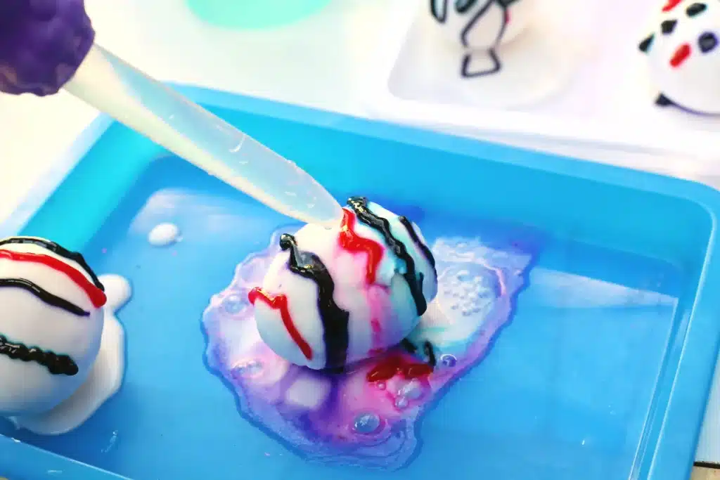 Galaxy Easter Eggs - Cultivating Brilliant Minds a pipette dropping vinegar on an egg covered in baking soda paste and food coloring