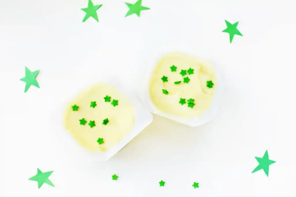 Sneetches Pudding Cups - Cultivating Brilliant Minds vanilla pudding cups with green star sprinkles inside