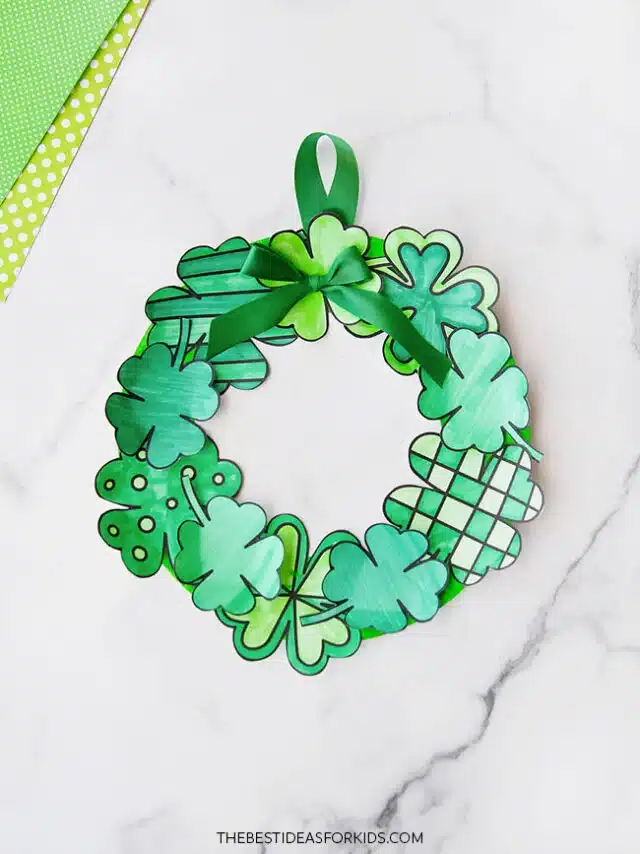 St. Patrick's Day Paper Plate Crafts - Cultivating Brilliant Minds a paper plate with shamrocks glued on it to make a wreath