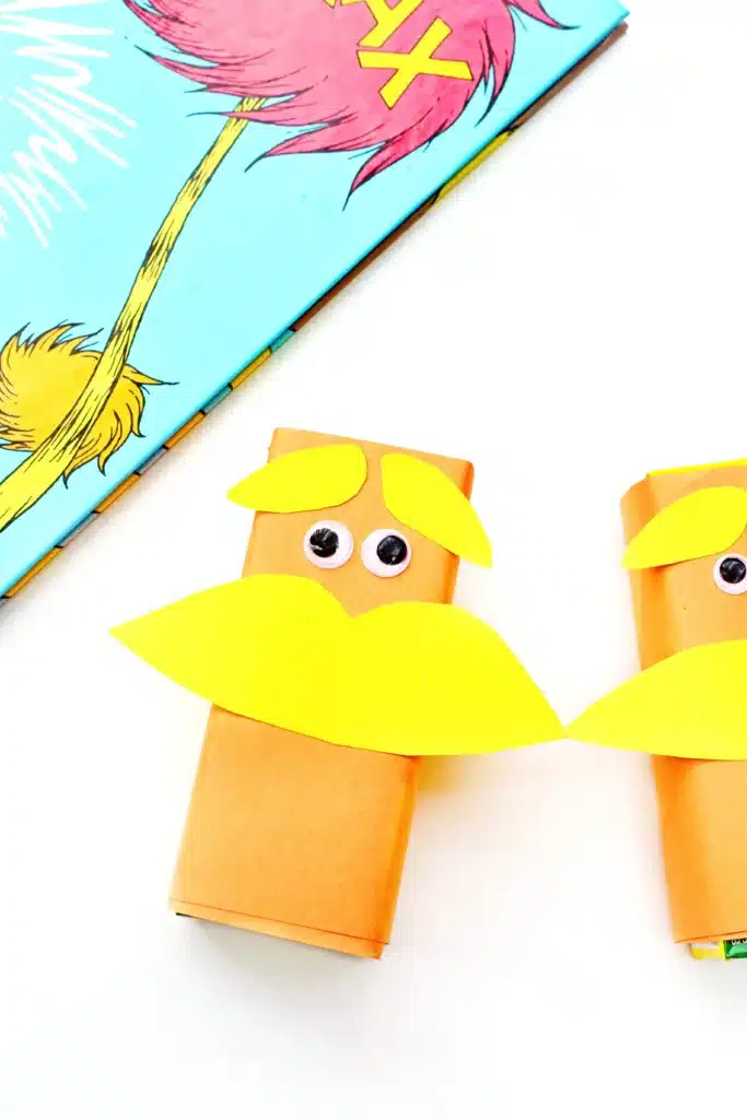 Dr. Seuss The Lorax Juice Boxes - Cultivating Brilliant Minds The Lorax Juice Boxes: juice boxes wrapped in orange paper and decorated to look like The Lorax next to Dr. Seuss's book "The Lorax"