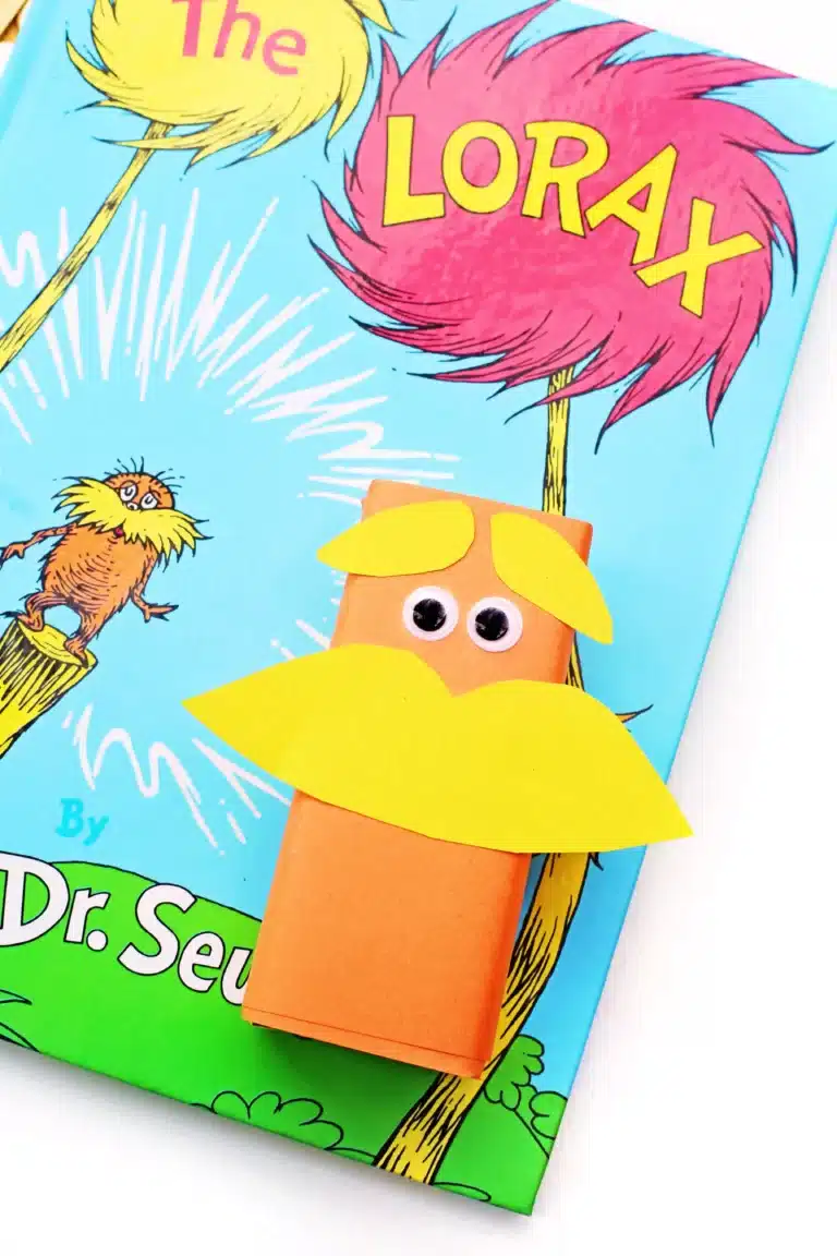 juice boxes wrapped in orange paper and decorated to look like The Lorax next to Dr. Seuss's book "The Lorax"