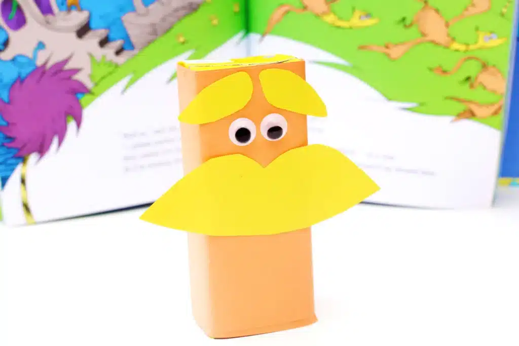 Dr. Seuss The Lorax Juice Boxes - Cultivating Brilliant Minds juice boxes wrapped in orange paper and decorated to look like The Lorax