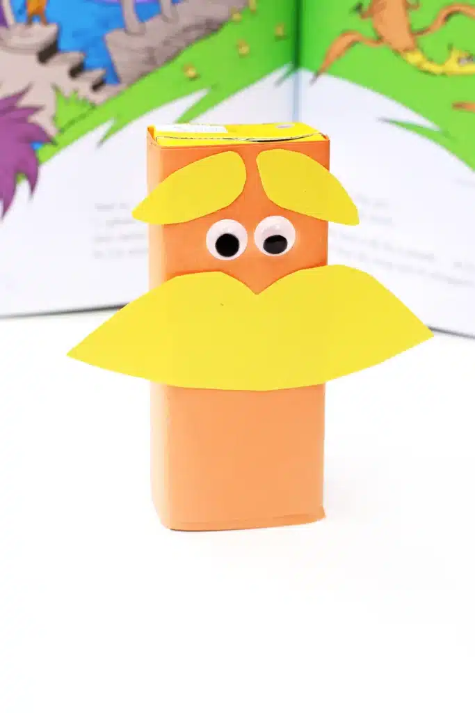 Dr. Seuss The Lorax Juice Boxes - Cultivating Brilliant Minds juice boxes wrapped in orange paper and decorated to look like The Lorax