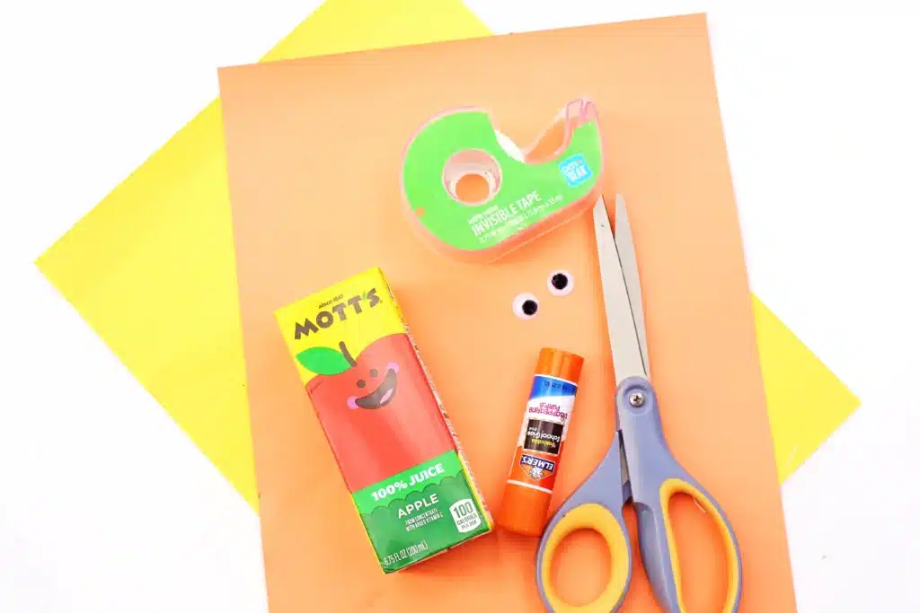 Dr. Seuss The Lorax Juice Boxes - Cultivating Brilliant Minds orange construction paper, apple juice, tape, googly eyes, glue, and scissors