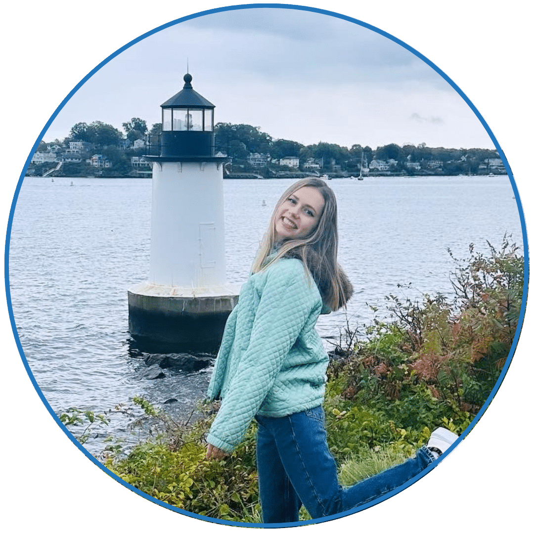 an image of a girl standing in front of a small light house