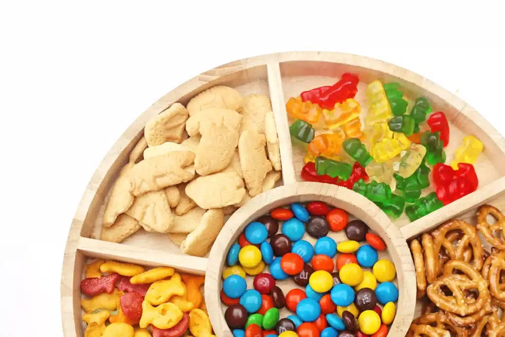 Zoo Snack Mix - Cultivating Brilliant Minds a zoo snack tray that has animal crackers, goldfish, pretzels, popcorn, m&ms and gummy bears