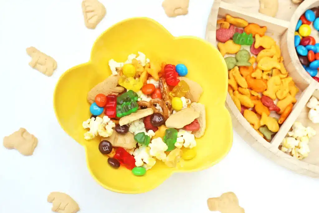 Zoo Snack Mix - Cultivating Brilliant Minds a zoo snack tray that has animal crackers, goldfish, pretzels, popcorn, m&ms and gummy bears