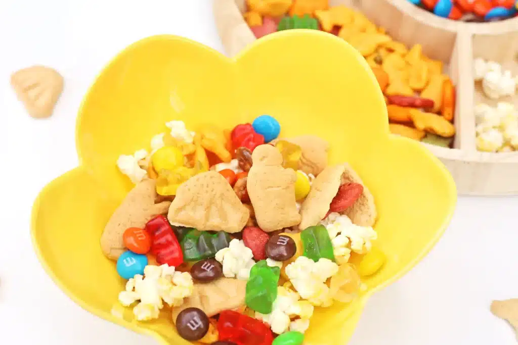 Zoo Snack Mix - Cultivating Brilliant Minds a zoo snack tray that has animal crackers, goldfish, pretzels, popcorn, m&ms and gummy bears