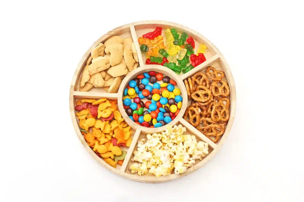 Zoo Snack Mix - Cultivating Brilliant Minds a zoo snack tray that has animal crackers, goldfish, pretzels, popcorn, m&ms and gummy bears