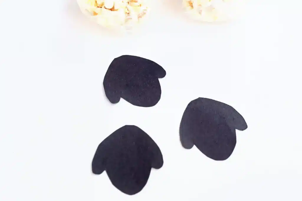 Sheep Popcorn Balls - Cultivating Brilliant Minds sheep head silhouette cut out of black construction paper