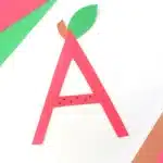 Letter A Apple Craft - Cultivating Brilliant Minds a letter a cut out of red construction paper with a leaf and stem glued on top