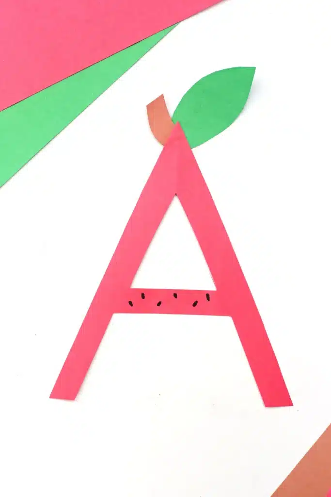 Letter A Apple Craft - Cultivating Brilliant Minds the letter a cut out of red construction paper with a leaf and stem glued on top