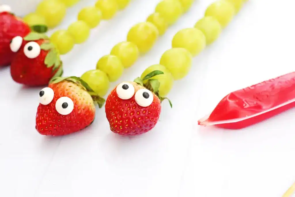 Caterpillar Grape Skewers - Cultivating Brilliant Minds skewers with grapes, a strawberry, and candy eyes on it to look like a caterpillar