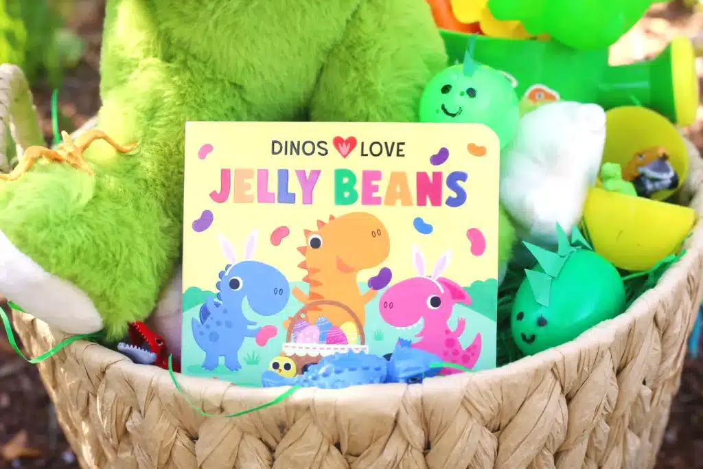 Dinosaur Easter Basket For Kids - Cultivating Brilliant Minds an easter basket with a book "Dinos love jelly beans" inside