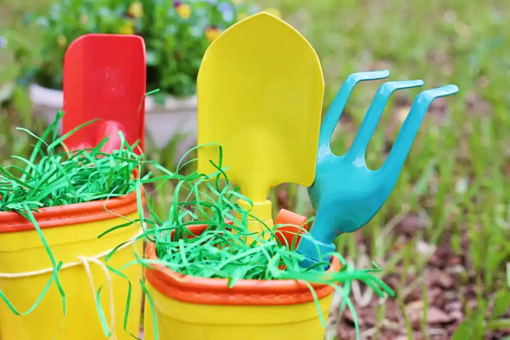 Rain boots Easter basket for kids - Cultivating Brilliant Minds rain boots with easter grass and toy garden tools inside