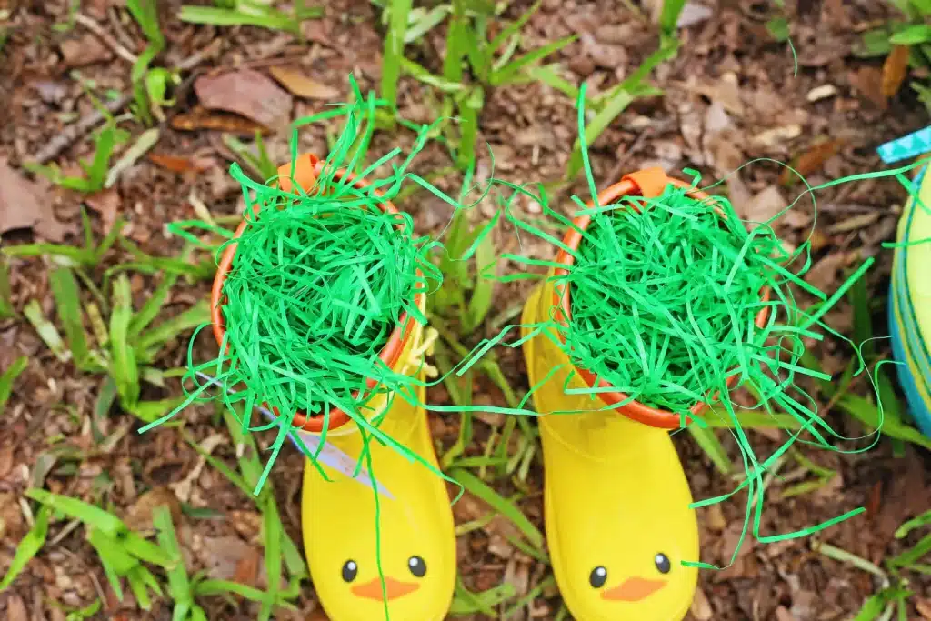 Rain boots Easter basket for kids - Cultivating Brilliant Minds rain boots with easter grass in them