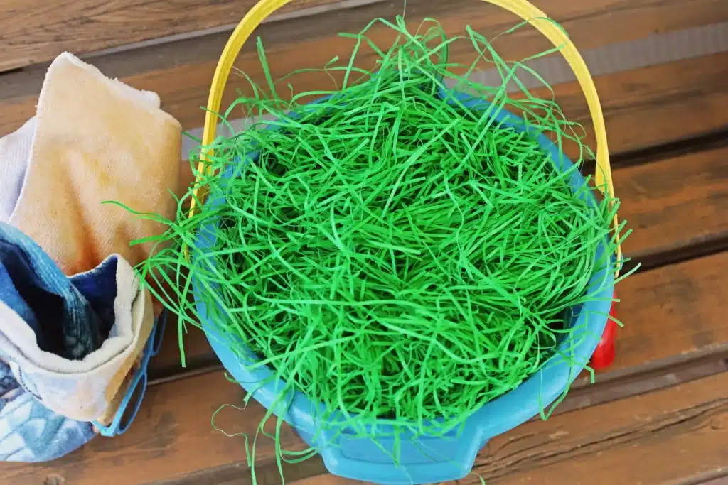 Beach Easter Basket Idea - Cultivating Brilliant Minds a beach bucket with easter grass in it