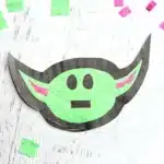 Baby Yoda Sun Catcher - Cultivating Brilliant Minds a star wars craft of a baby yoda sun catcher made from construction paper, tissue paper, and contact paper