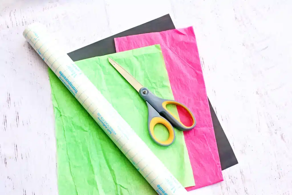 Baby Yoda Sun Catcher - Cultivating Brilliant Minds contact paper, green and pink tissue paper, black construction paper, and scissors