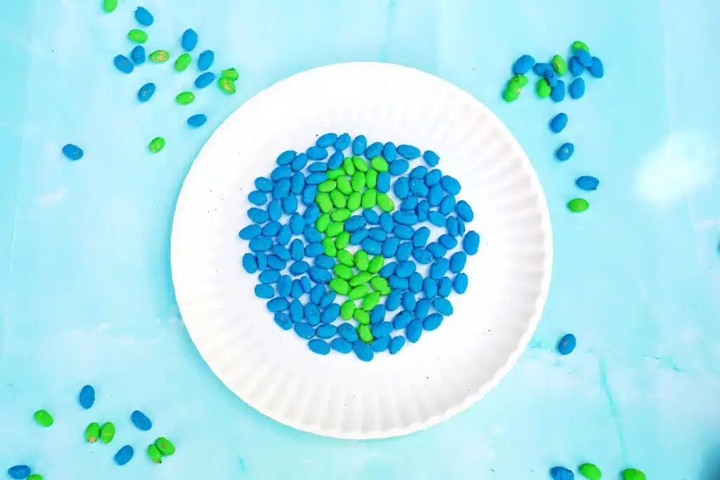 Bean Earth Day Mosaic - Cultivating Brilliant Minds a bean earth day mosaic made out of painted dry beans glued onto a paper plate