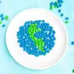 Bean Earth Day Mosaic - Cultivating Brilliant Minds an earth day art project that uses green and blue dyed pinto beans glued to a paper plate in the shape of the earth