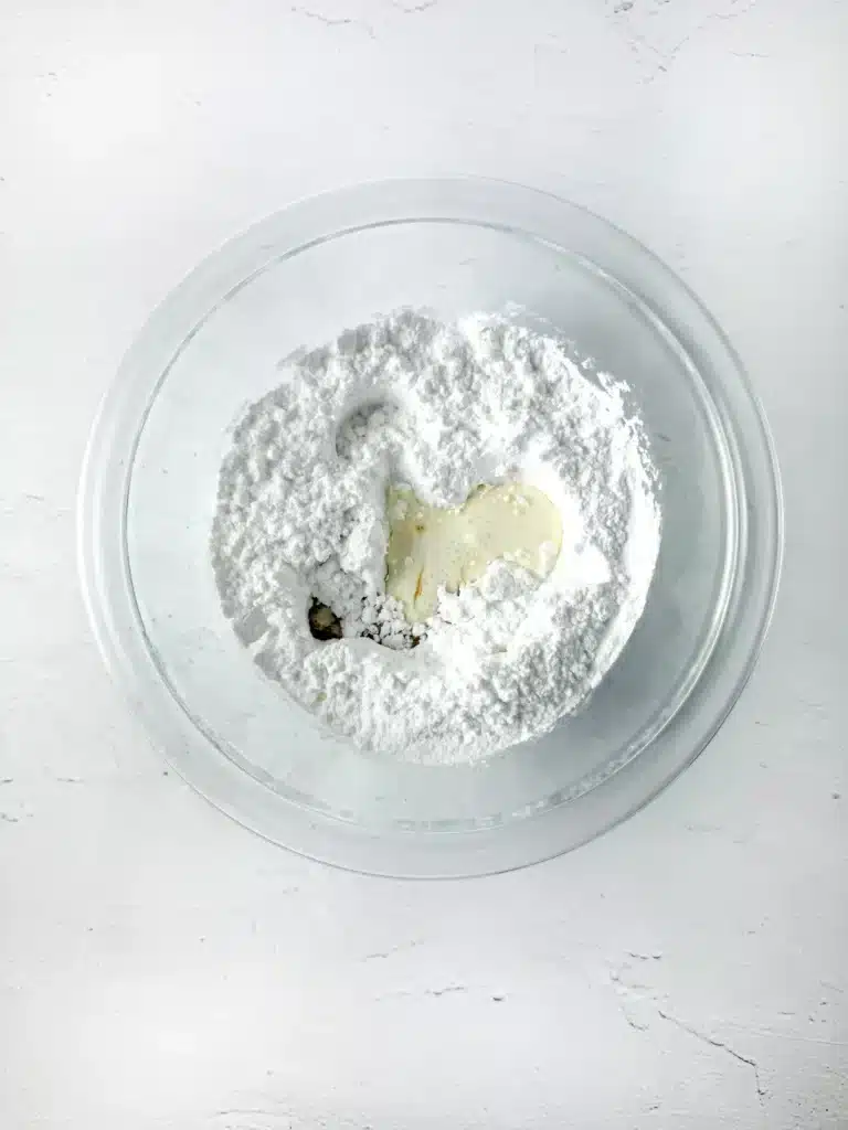 Blueberry Earth Day Hand Pies - Cultivating Brilliant Minds powdered sugar, vanilla, and heavy cream in a bowl