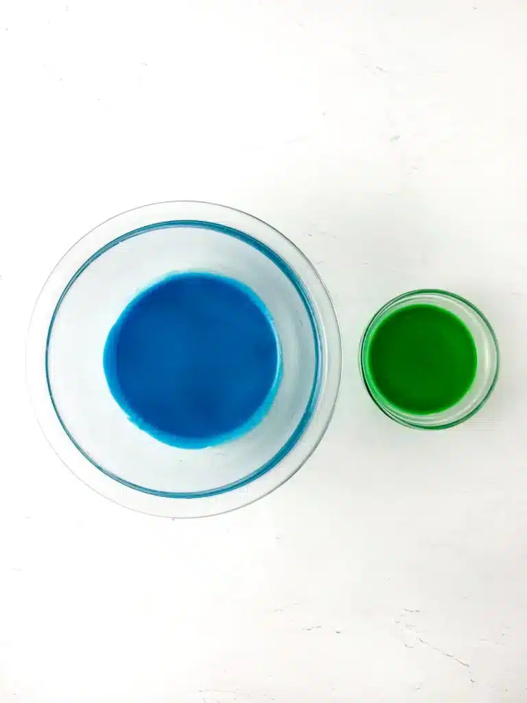 Blueberry Earth Day Hand Pies - Cultivating Brilliant Minds green and blue icing in bowls