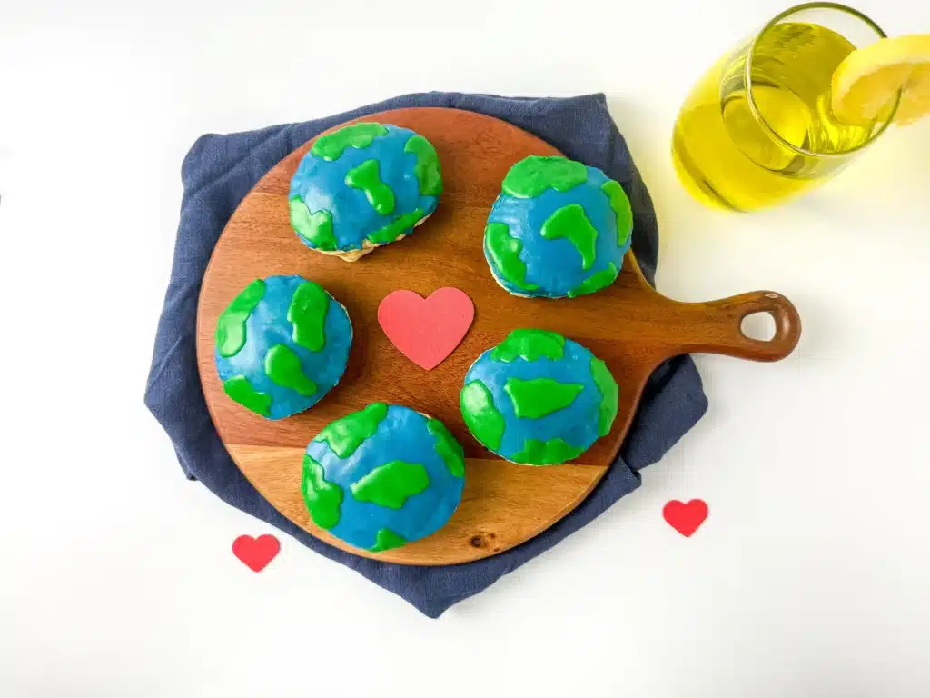 Blueberry Earth Day Hand Pies - Cultivating Brilliant Minds hand pies in the shape of a circle with blue and green icing on top to look like the Earth