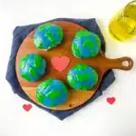 Blueberry Earth Day Hand Pies - Cultivating Brilliant Minds hand pies in the shape of a circle with blue and green icing on top to look like the Earth