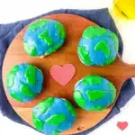Blueberry Earth Day Hand Pies - Cultivating Brilliant Minds hand pies in the shape of a circle with blue and green icing on top to look like the Earth