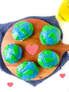 hand pies in the shape of a circle with blue and green icing on top to look like the Earth