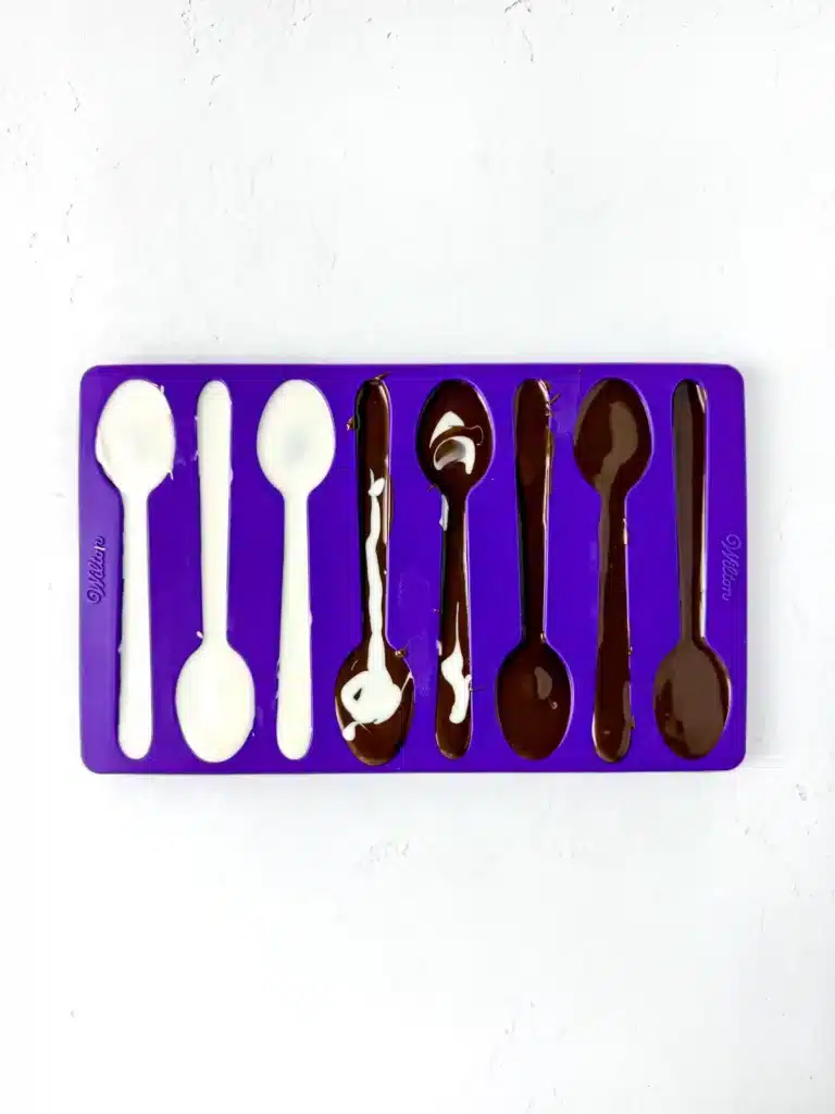 Bunny Chocolate Spoons - Cultivating Brilliant Minds a spoon mold filled with melted chocolate and melted white chocolate