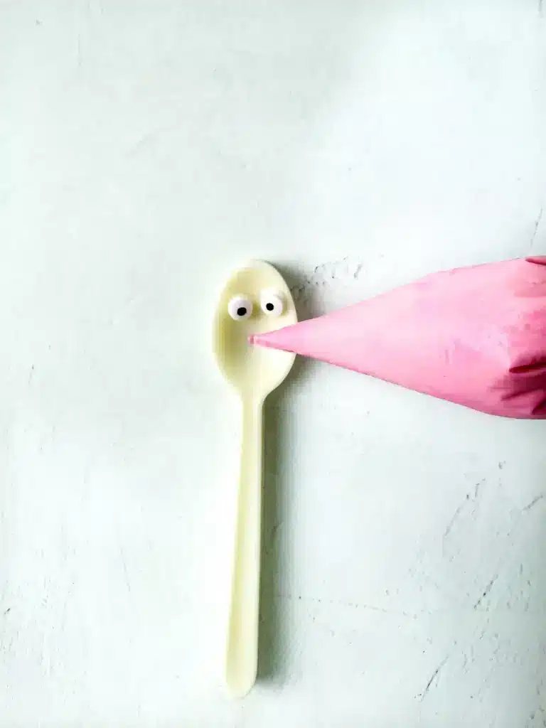 Bunny Chocolate Spoons - Cultivating Brilliant Minds a white chocolate spoon with candy eyes