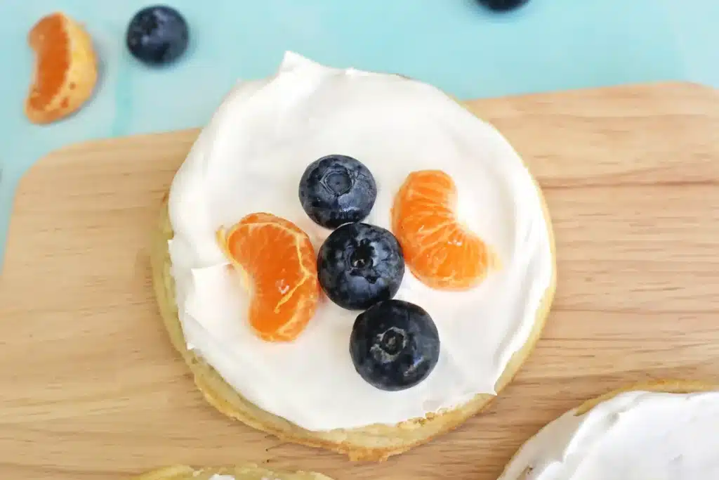 Butterfly Garden Waffles: A Spring Breakfast Idea For Kids - Cultivating Brilliant Minds waffles with whipped cream and blueberries and oranges arranged to look like a butterfly