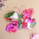Butterfly Nature Collage - Cultivating Brilliant Minds a butterfly drawn on cardboard with flowers and leaves glued on it