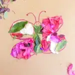 Butterfly Nature Collage - Cultivating Brilliant Minds a butterfly drawn on cardboard with flowers and leaves glued on it