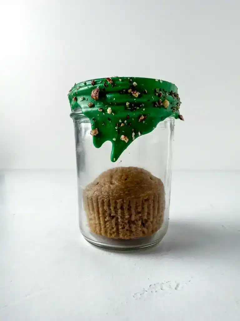Carrot Cake Jars For Easter - Cultivating Brilliant Minds a carrot cupcake inside a jar with green chocolate dripping down the top