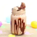 a chocolate milkshake that has a chocolate bunny on top