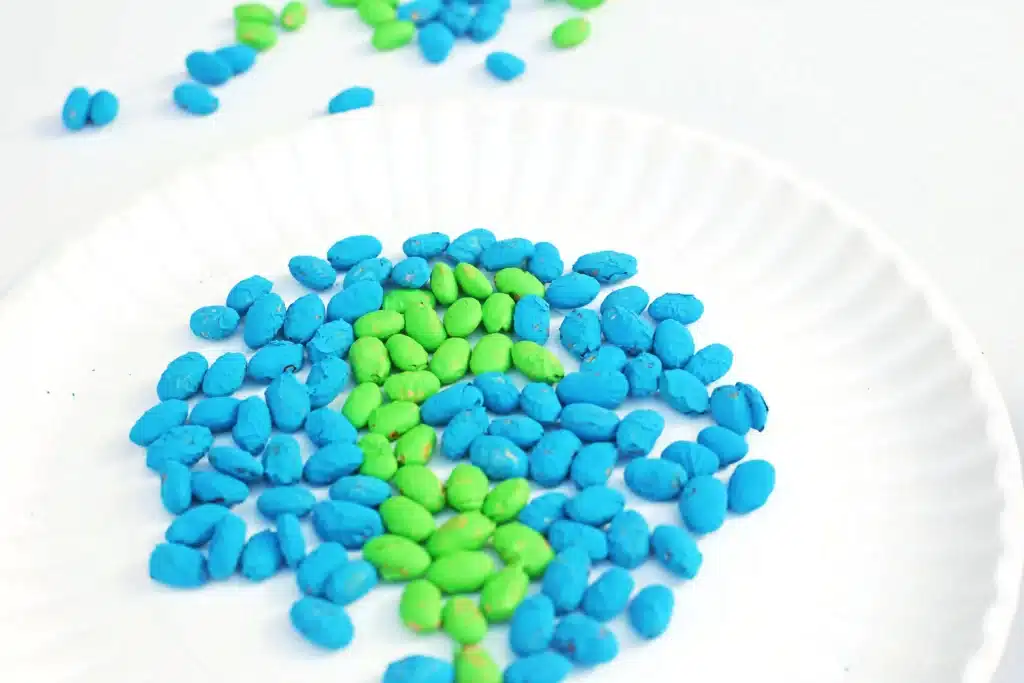 Bean Earth Day Mosaic - Cultivating Brilliant Minds green and blue dyed pinto beans glued to a paper plate to look like the earth