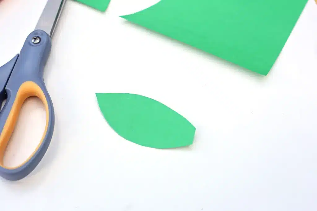 Letter A Apple Craft - Cultivating Brilliant Minds a leaf cut out of green construction paper