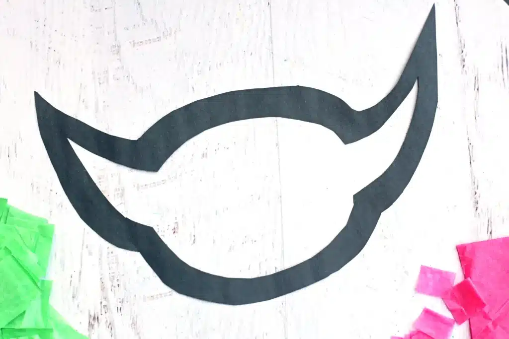 Baby Yoda Sun Catcher - Cultivating Brilliant Minds an outline of a baby yoda head cut out of black construction paper