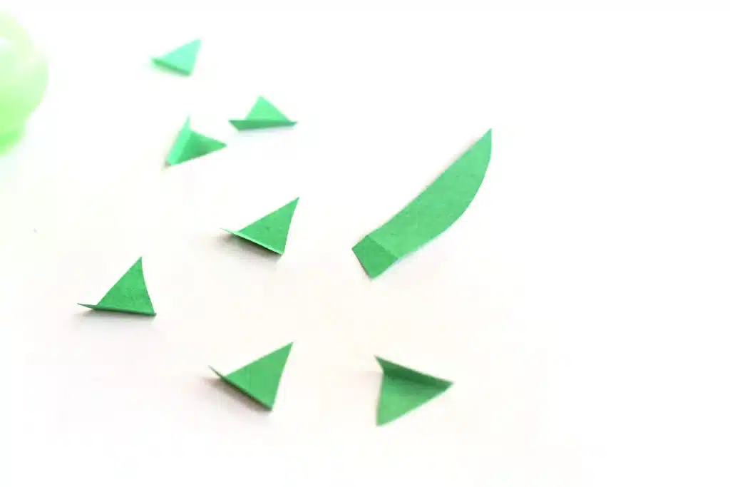 Dinosaur Easter Basket For Kids - Cultivating Brilliant Minds green construction paper cut into triangles to look like dinosaur spikes
