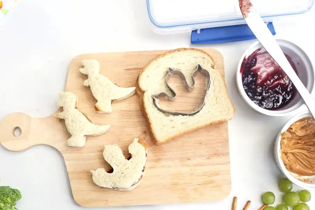 Dinosaur Lunch Idea - Cultivating Brilliant Minds a sandwich cut into dinosaur shapes with cookie cutters