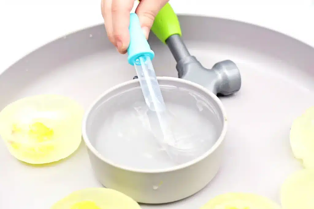 Frozen Chick Rescue Activity - Cultivating Brilliant Minds a kid putting a pipette in warm water