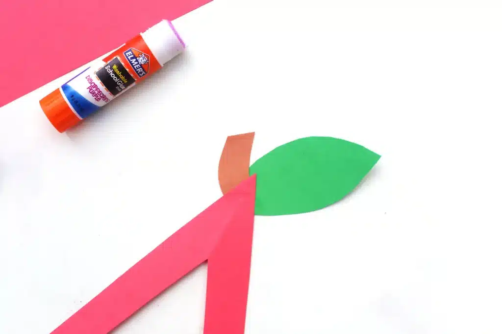 Letter A Apple Craft - Cultivating Brilliant Minds the letter a cut out of red construction paper with a leaf and stem glued on top