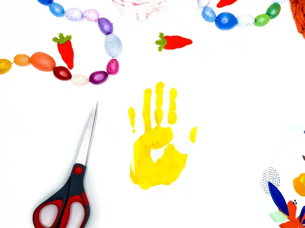 Chick Handprint Craft - Cultivating Brilliant Minds a yellow paint handprint on a piece of paper to create the body of the chick for this keepsake craft