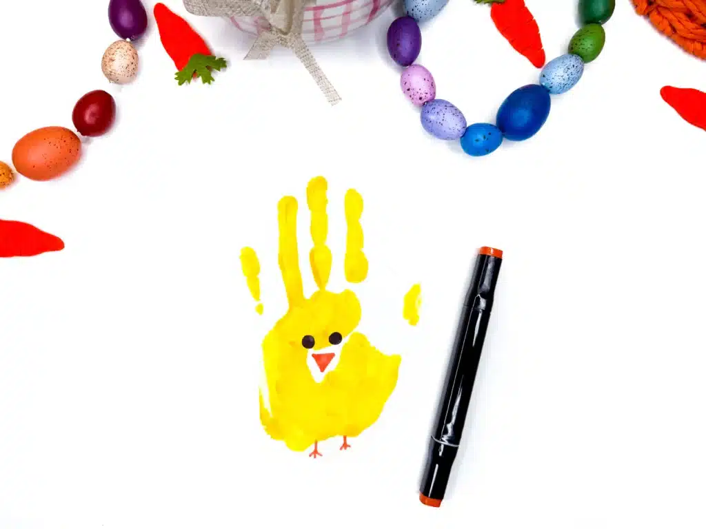 Chick Handprint Craft - Cultivating Brilliant Minds an easy craft for kids that is a paint handprint on paper with eyes, a beak, and feet drawn on to look like a chick