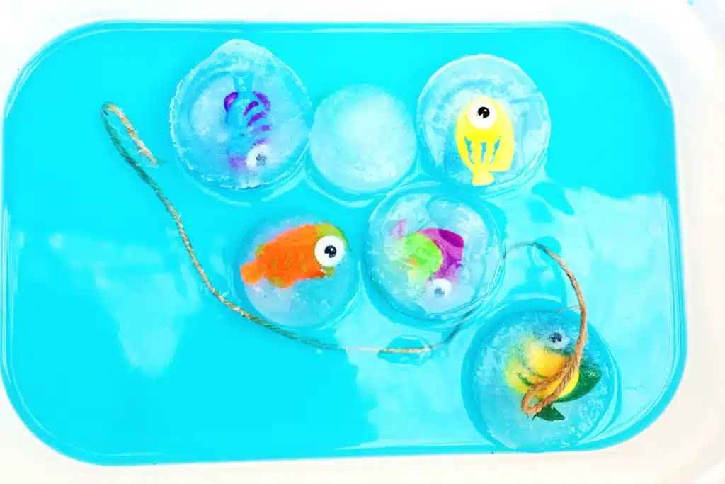 Ice Fishing Sensory Bin - Cultivating Brilliant Minds an ice fishing sensory bin that has water and toy fish frozen in ice